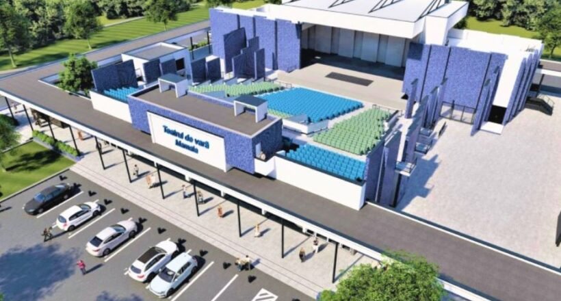 A rendered aerial view of a modern sports arena with blue and green seating, a large entrance, and a parking lot nearby.