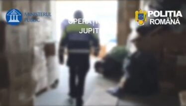 Blurred hallway scene with a uniformed officer walking away; Romanian police logos (Ministerul Public, Poliția Română) are visible in the frame, suggesting a police operation.