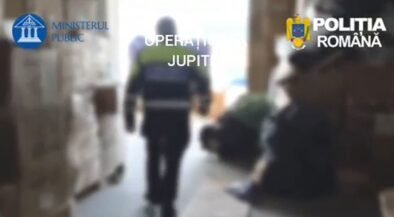 Blurred hallway scene with a uniformed officer walking away; Romanian police logos (Ministerul Public, Poliția Română) are visible in the frame, suggesting a police operation.