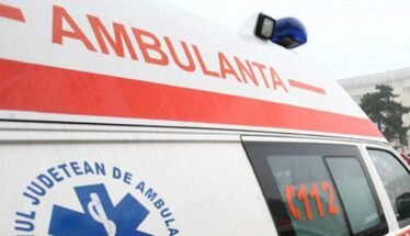 Ambulance with a red stripe and blue medical emblem, 112 visible on the side window.