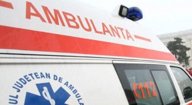 Ambulance with a red stripe and blue medical emblem, 112 visible on the side window.
