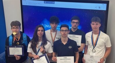 Six students pose with diplomas and medals after an awards ceremony, in front of a blue starry backdrop.