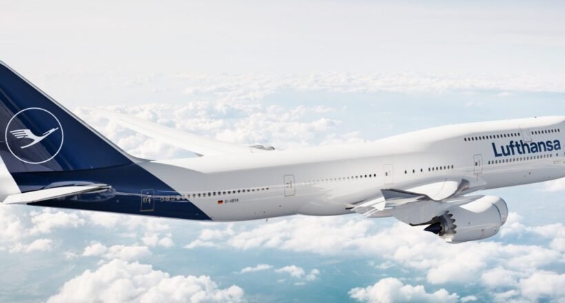 Lufthansa airliner flying above clouds, white fuselage with blue tail and Lufthansa logo