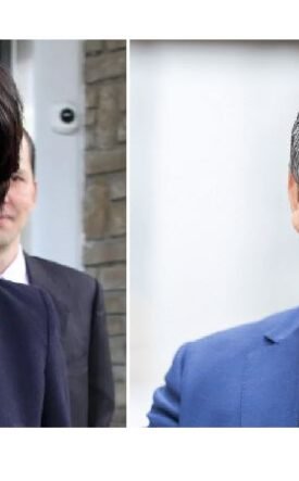 Two professionals, a woman on the left wearing a scarf and a man on the right in a blue suit, pictured side by side outdoors/entrance area.