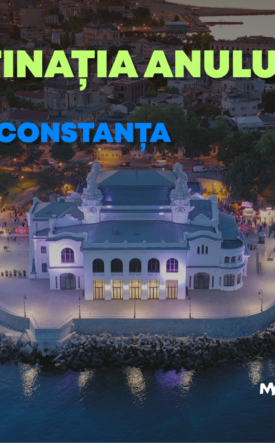 Aerial view of a illuminated casino on a rocky peninsula at dusk promoting Gala Destinația Anului 2026 at the Constanța Casino.
