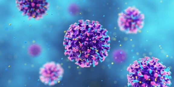 Colorful coronavirus–like particles floating in a blue background, showing spike proteins on purple bodies.