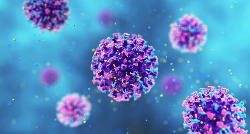 Colorful coronavirus–like particles floating in a blue background, showing spike proteins on purple bodies.