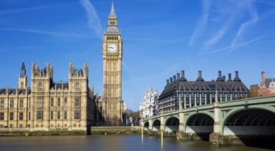 Big Ben (Elizabeth Tower) with the Houses of Parliament and Westminster Bridge across the River Thames on a sunny day in London.