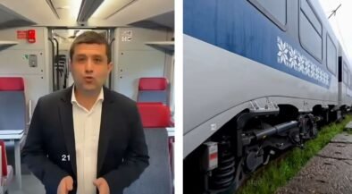 Split image: a man in a dark suit speaking to the camera inside a train carriage, with red seats behind him; on the right, a blue and white passenger train on tracks.