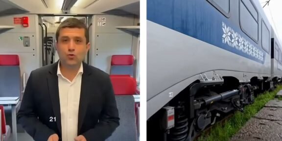 Split image: a man in a dark suit speaking to the camera inside a train carriage, with red seats behind him; on the right, a blue and white passenger train on tracks.