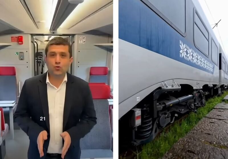 Split image: a man in a dark suit speaking to the camera inside a train carriage, with red seats behind him; on the right, a blue and white passenger train on tracks.