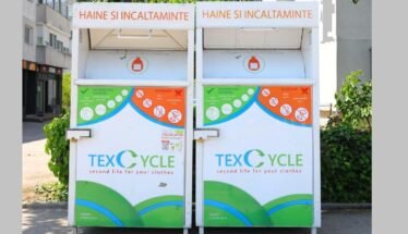 Two large white textile recycling bins labeled TEX CYCLE for clothing and shoes, with green and blue graphic panels.