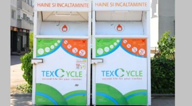 Two large white textile recycling bins labeled TEX CYCLE for clothing and shoes, with green and blue graphic panels.