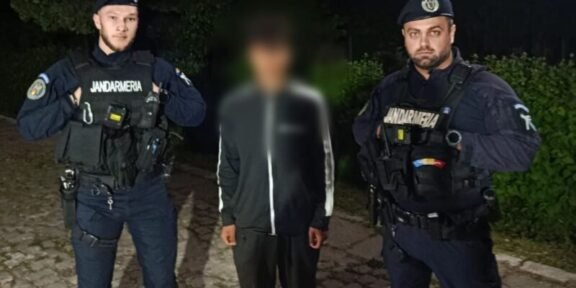 Two gendarmes in tactical gear flank a blurred civilian on a cobblestone path at night.