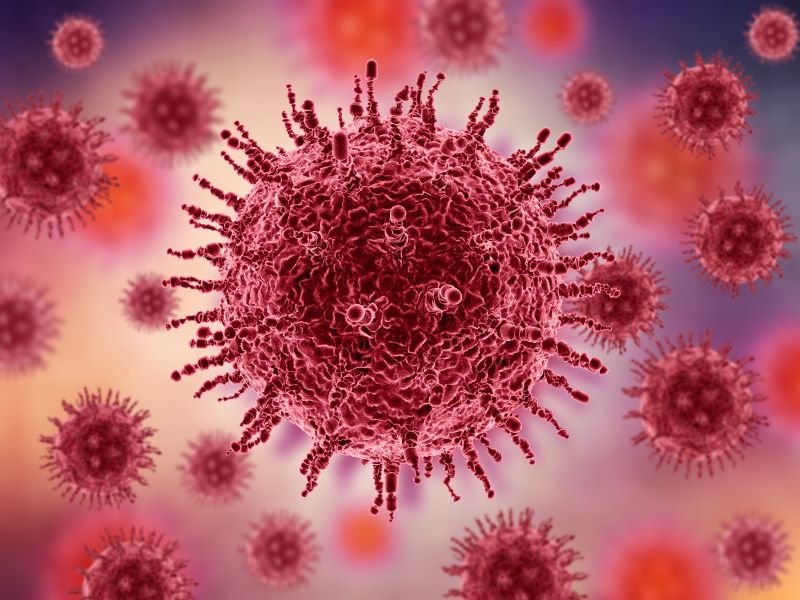 Close-up illustration of a red virus particle with spike proteins against a pink-purple blurred background.