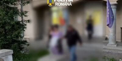 Blurry outdoor scene outside a building with the Romanian Police logo at the top, a European flag on a pole, and several people walking by.