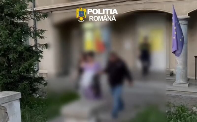 Blurry outdoor scene outside a building with the Romanian Police logo at the top, a European flag on a pole, and several people walking by.