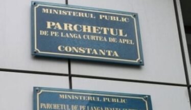 Two blue signs on a wall reading 'Ministerul Public' and 'Parchetul de pe lângă Curtea de Apel Constanța' (Constanța Public Prosecutor's Office).
