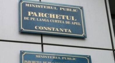 Two blue signs on a wall reading 'Ministerul Public' and 'Parchetul de pe lângă Curtea de Apel Constanța' (Constanța Public Prosecutor's Office).