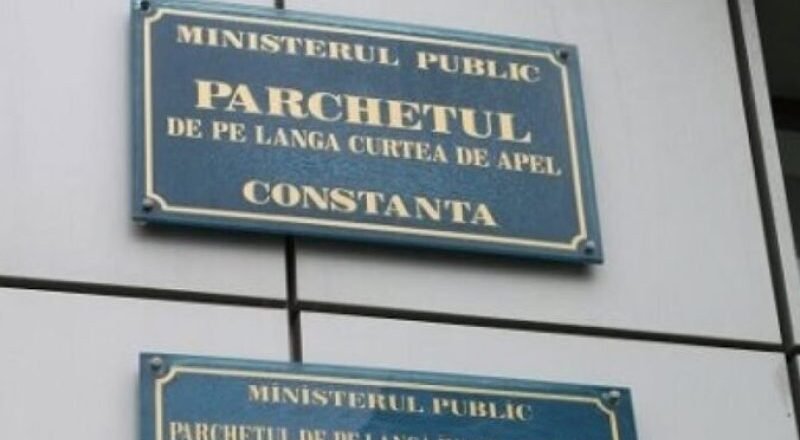Two blue signs on a wall reading 'Ministerul Public' and 'Parchetul de pe lângă Curtea de Apel Constanța' (Constanța Public Prosecutor's Office).