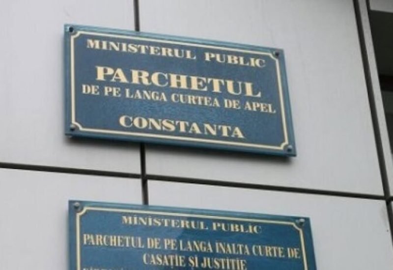 Two blue signs on a wall reading 'Ministerul Public' and 'Parchetul de pe lângă Curtea de Apel Constanța' (Constanța Public Prosecutor's Office).