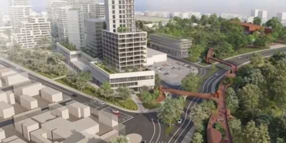 Aerial rendering of a modern urban district: a tall central tower, surrounding low-rise buildings, green parks, and an elevated pedestrian walkway weaving over curved roads.